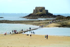 Visitors leaving the Grand Bé as the tide comes in, St-Malo, Brittany, France