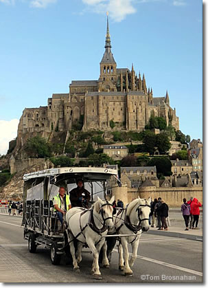 A maringote (horse-drawn carriage) returns from Mont St-Michel to mainland France